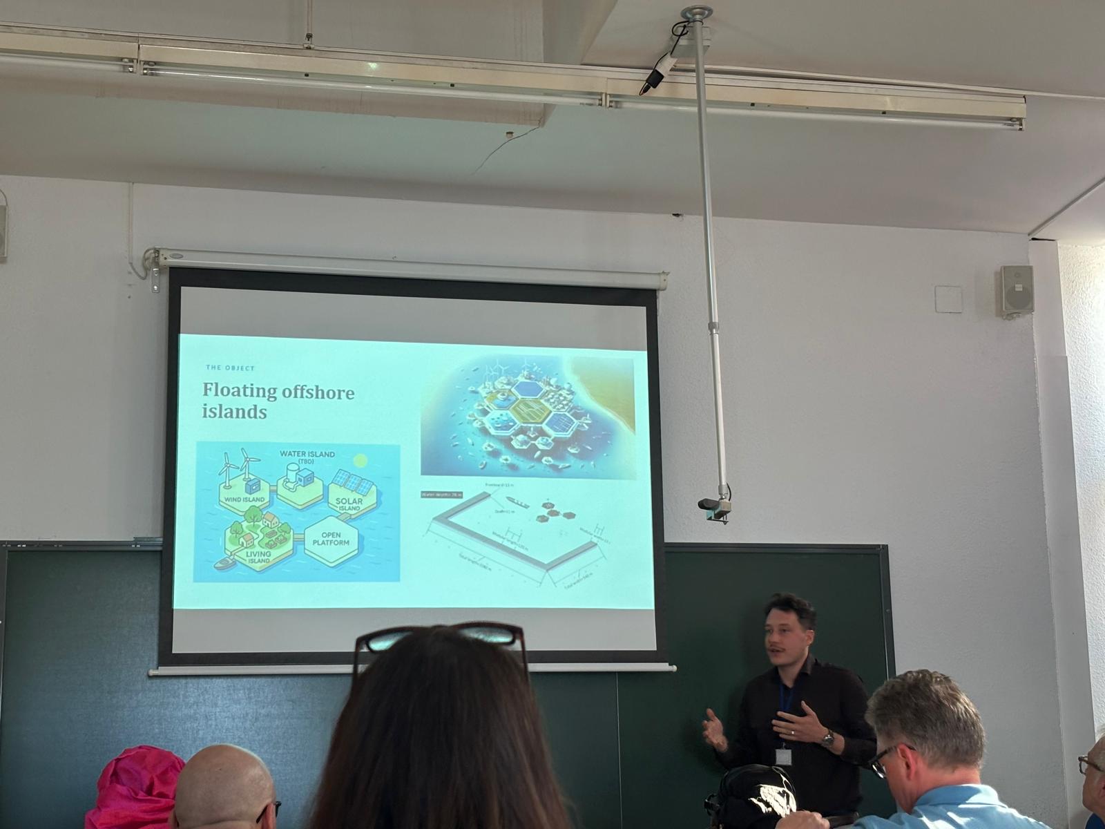 Wide view of a lecture hall during a presentation on floating offshore islands