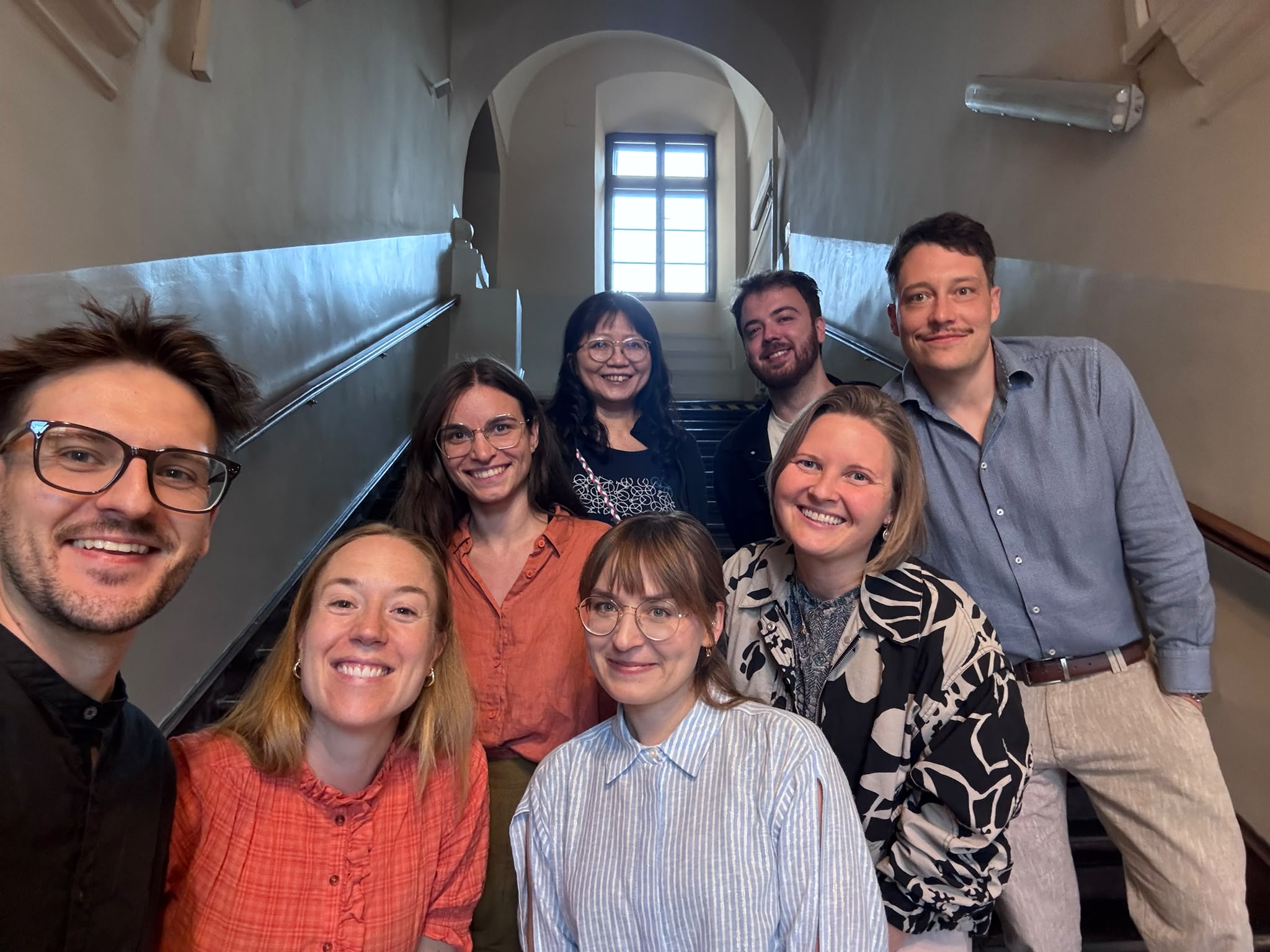 Workshop participants gathered on a staircase at ul. Grodzka 52 in Kraków